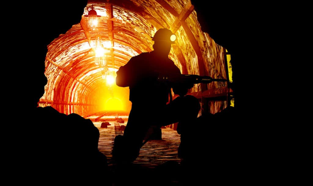 Silhouettes of worker in the mine
