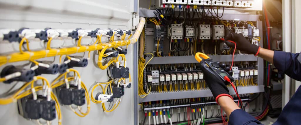 A person performing transformer repair in El Paso.